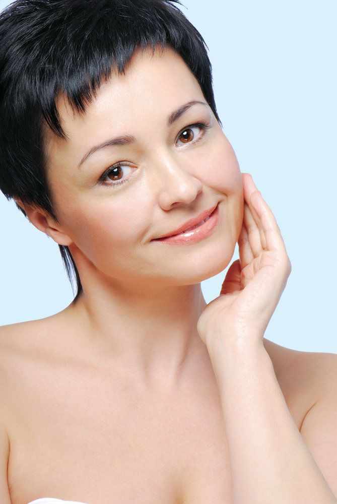 woman touching her cheek